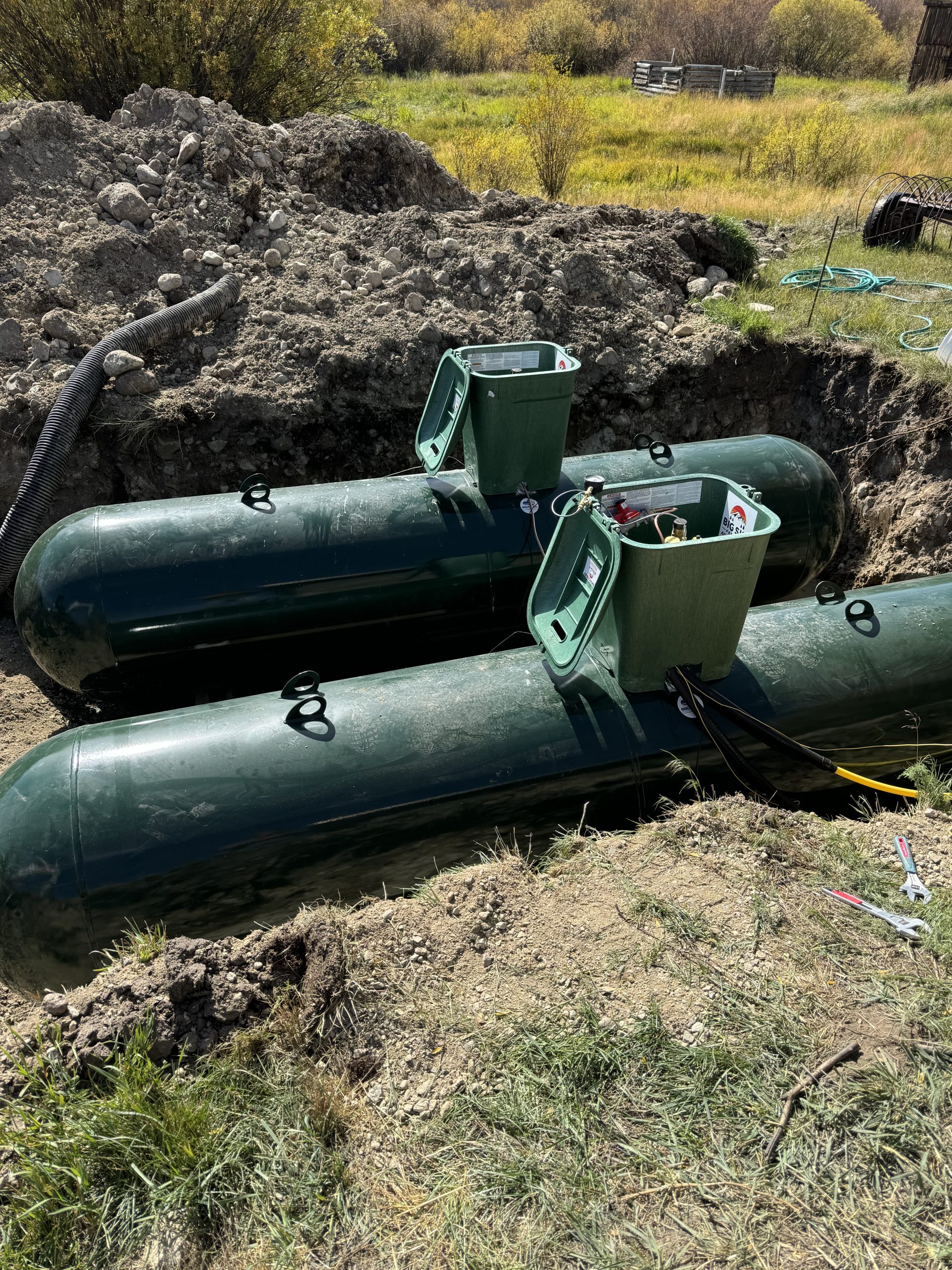 Green propane tanks being buried
